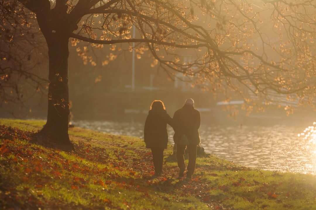 elderly couple walking in park
